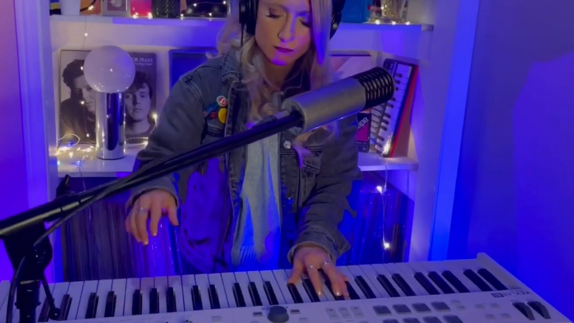 Picture of Dana Jean Phoenix playing am organ in a room with blue lighting.
