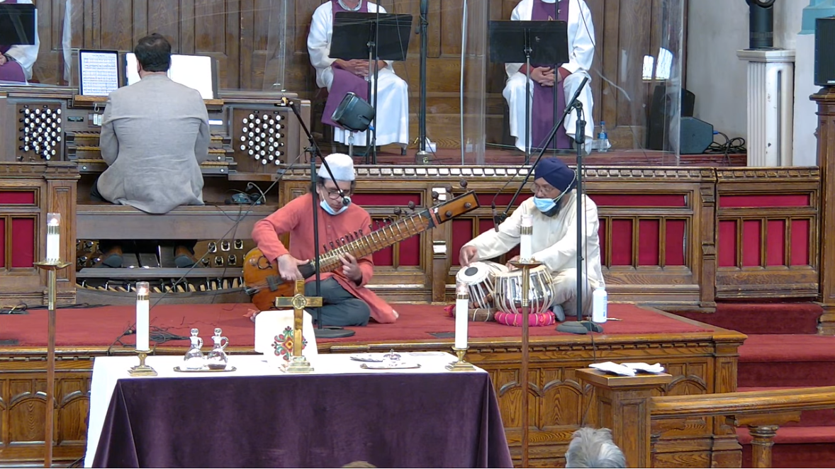 Picture of Anwar Khurshid playing a sitar and Jaswinder Singh Sraa playing tabla in the Sanctuary.