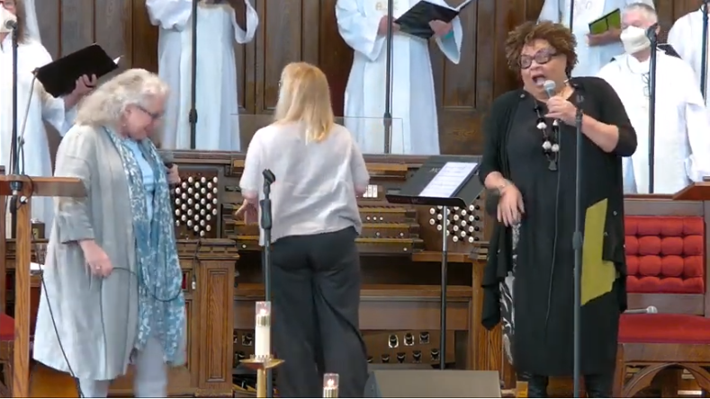 Picture of Julie Michels and Jackie Richardson singing in the sanctuary