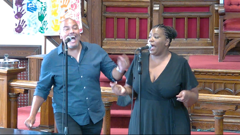 Picture of Alana Bridgewater and Gavin Hope , singing.