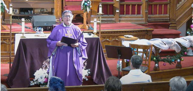Rev. Deana preaching at the pulpit.