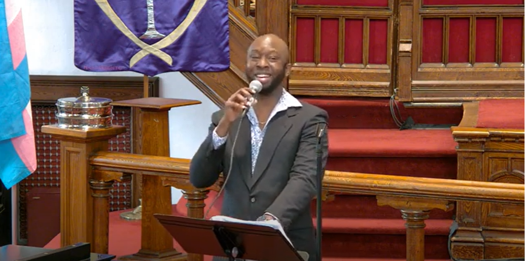 Abraham Millington singing at the pulpit.