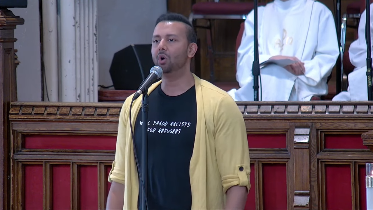 Picture of Andrew Prashad singing at the sanctuary of MCC Toronto