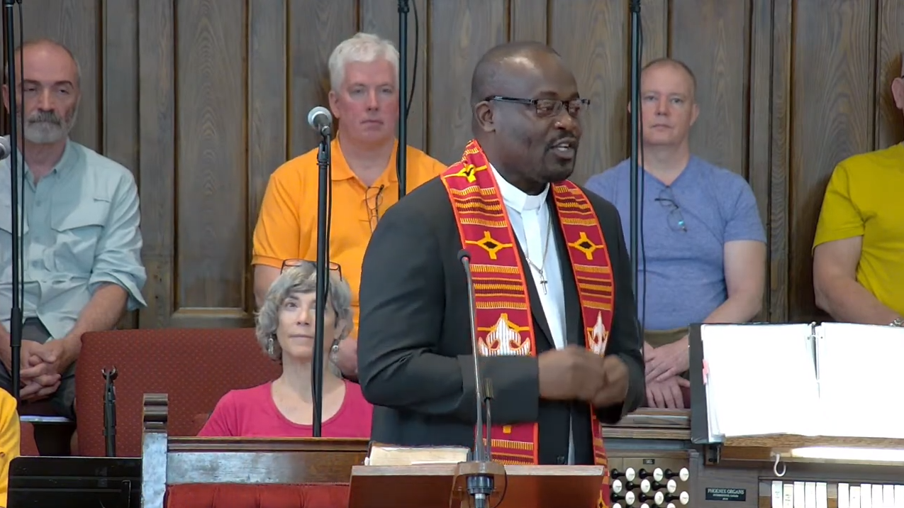 Picture of Sherwin Modeste speaking at the pulpit of MCC Toronto