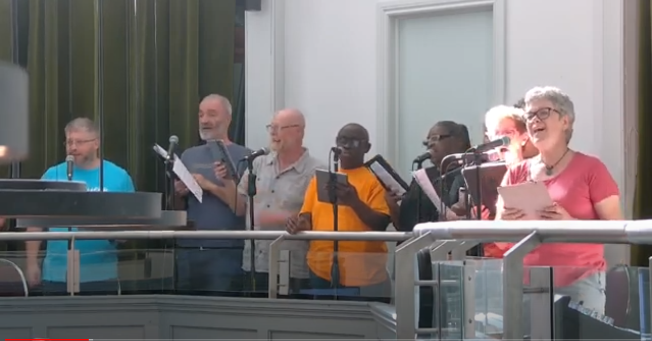 Picture of Choir of MCC Toronto singing on the balcony of the Sanctuary