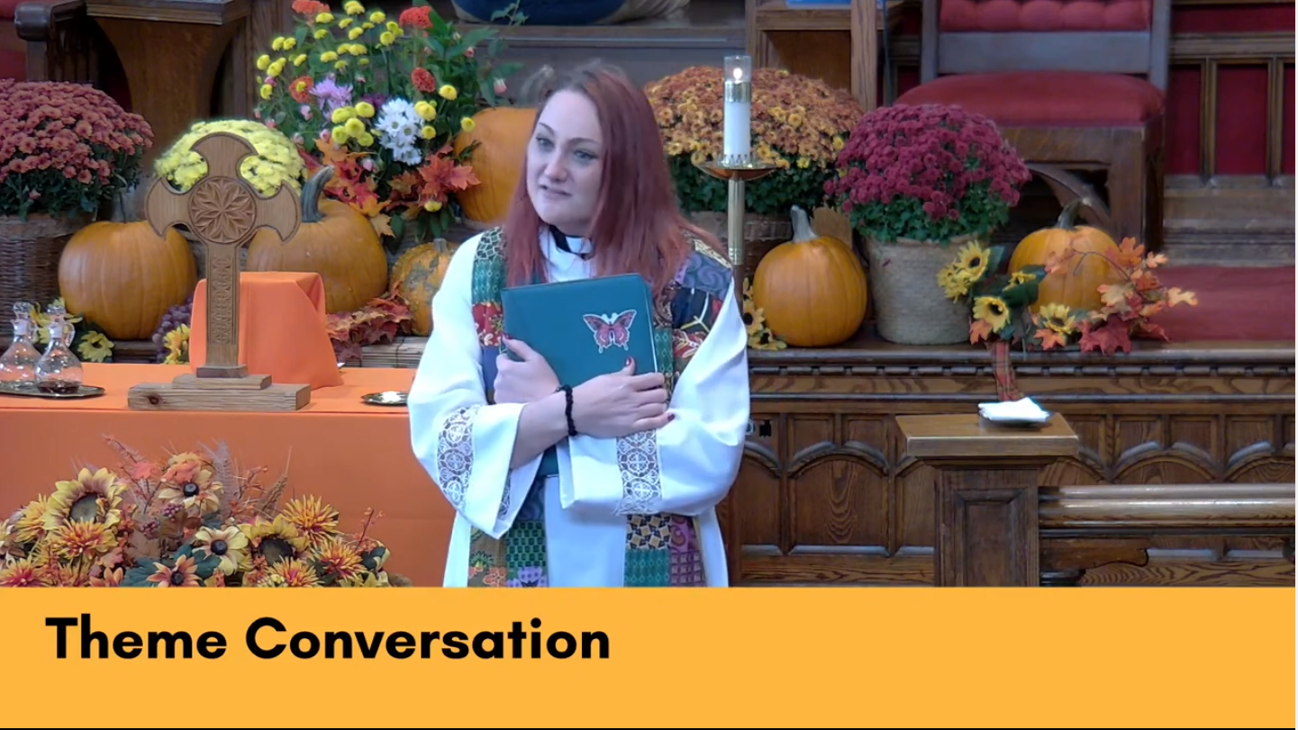Picture of Rev. June at the podium of the Sanctuary in front of a patch of pumpkins on the stage behind her, and text saying," Theme conversations"